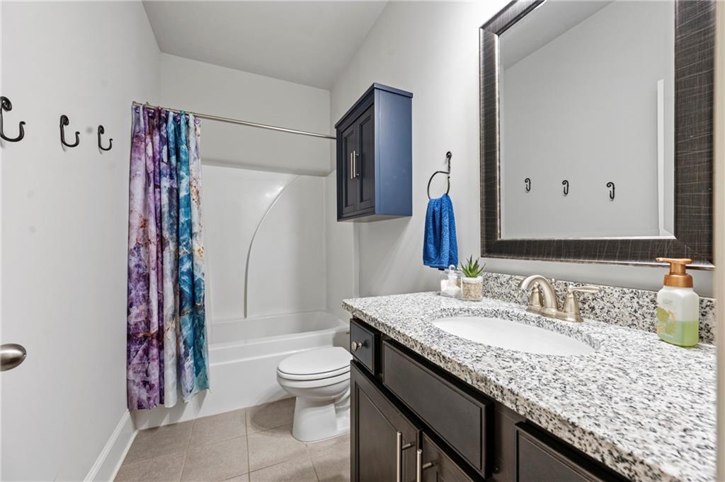 6780 Rambling Vale Dawsonville, GA 30534 - Photo 21 of 53 a bathroom with a granite countertop sink toilet and shower