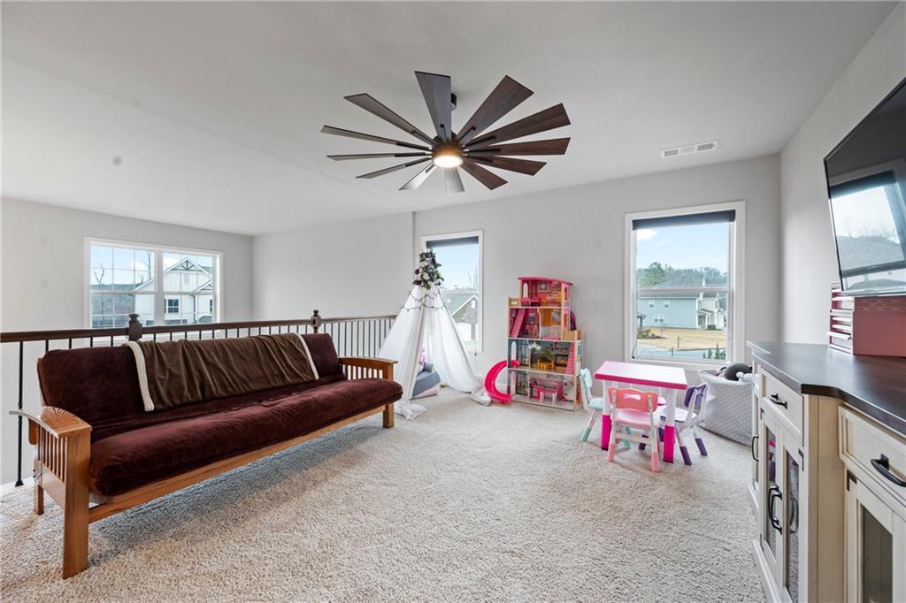 6780 Rambling Vale Dawsonville, GA 30534 - Photo 27 of 53 a living room with furniture a flat screen tv and a window