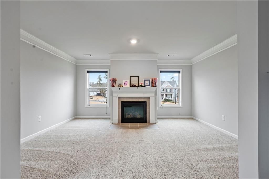 6780 Rambling Vale Dawsonville, GA 30534 - Photo 31 of 53 a view of an empty room with a fireplace and a window