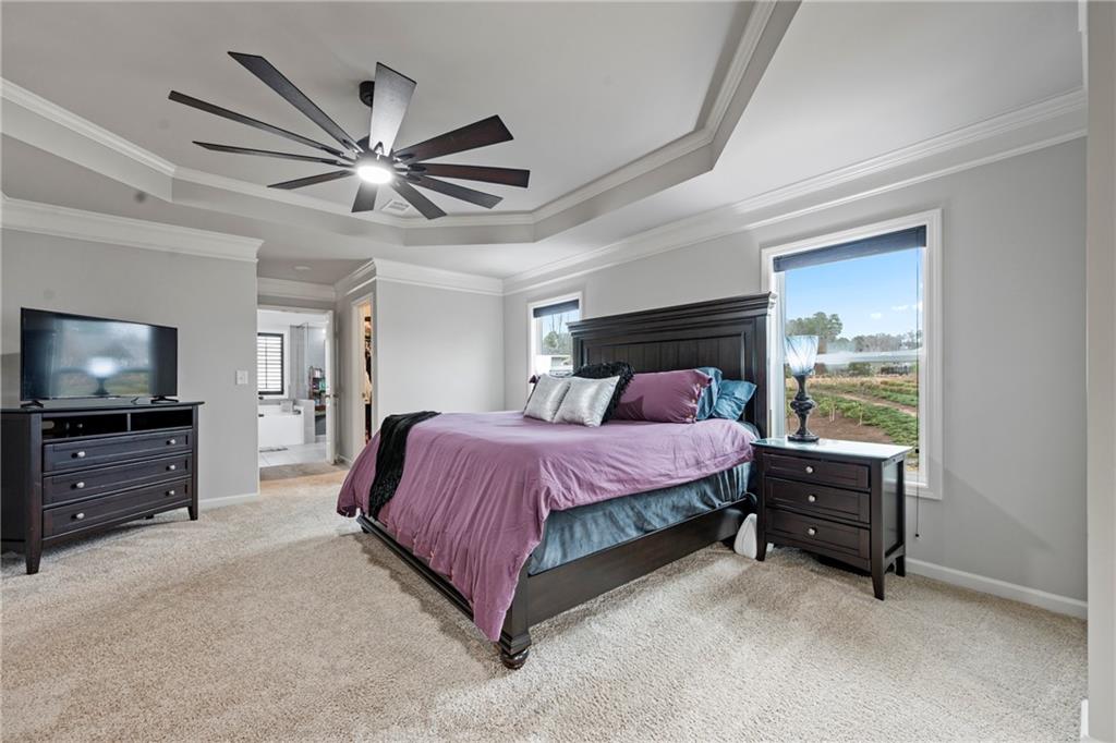 6780 Rambling Vale Dawsonville, GA 30534 - Photo 32 of 53 a spacious bedroom with a bed and a flat screen tv