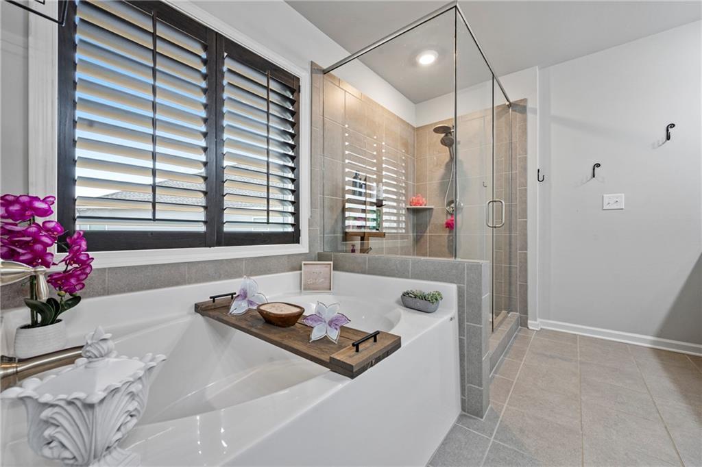 6780 Rambling Vale Dawsonville, GA 30534 - Photo 36 of 53 a bathroom with a tub sink and a mirror