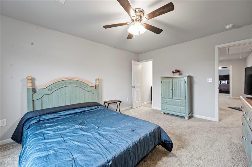 6780 Rambling Vale Dawsonville, GA 30534 - Photo 39 of 53 a bedroom with a bed and a chandelier