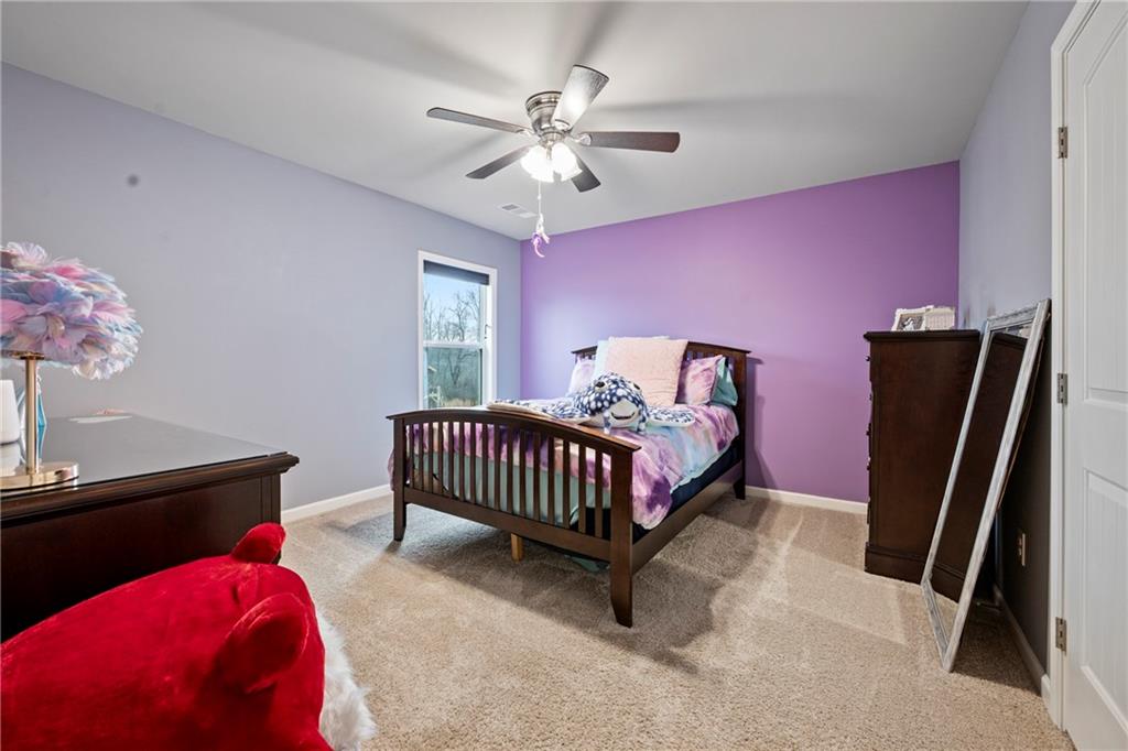 6780 Rambling Vale Dawsonville, GA 30534 - Photo 41 of 53 a bedroom with a bed and a chandelier