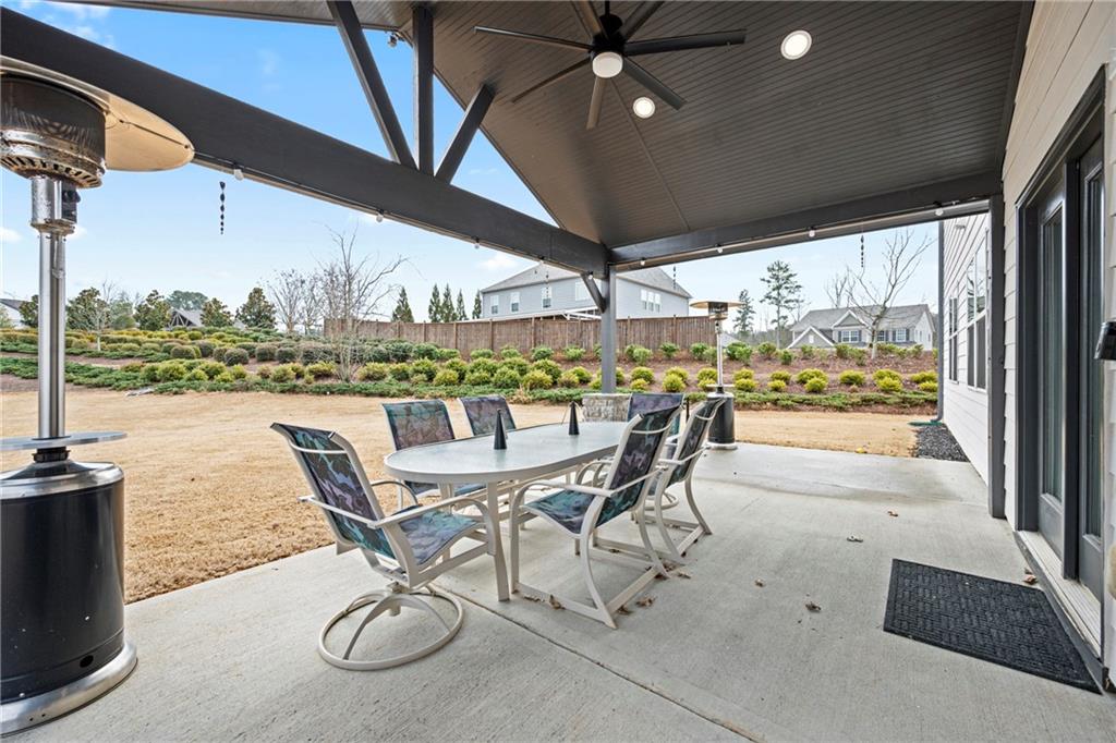 6780 Rambling Vale Dawsonville, GA 30534 - Photo 44 of 53 a view of a swimming pool with a table and chairs under an umbrella