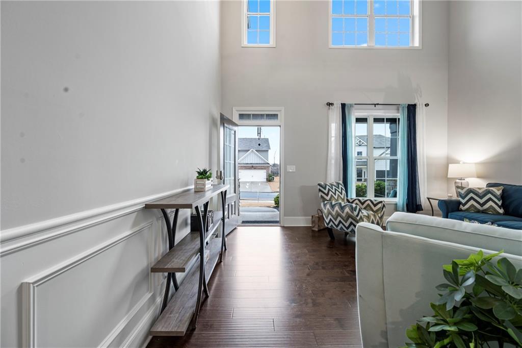 6780 Rambling Vale Dawsonville, GA 30534 - Photo 8 of 53 a hallway with wooden floor and furniture