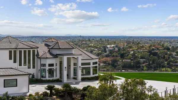 an aerial view of a house with a yard