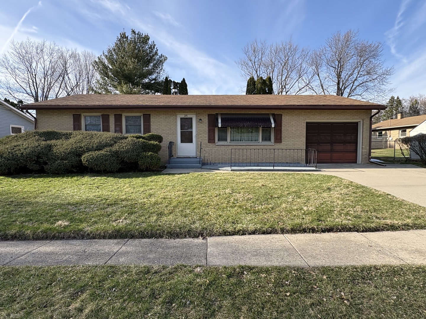 215 Phyllis Avenue Rochelle, IL 61068 - Photo 1 of 27 a front view of a house with a yard and garage