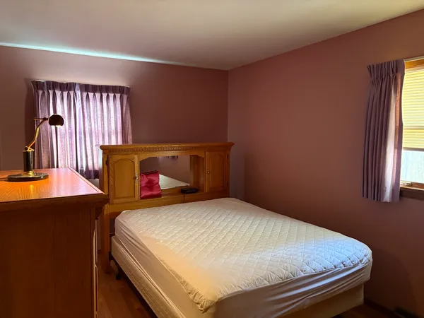 a bedroom with a bed and window