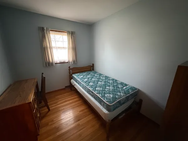 a living room with a bed and a window