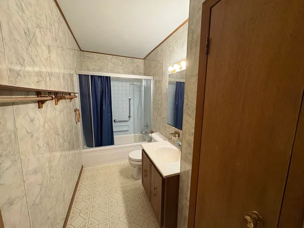 a bathroom with a sink a mirror and a shower