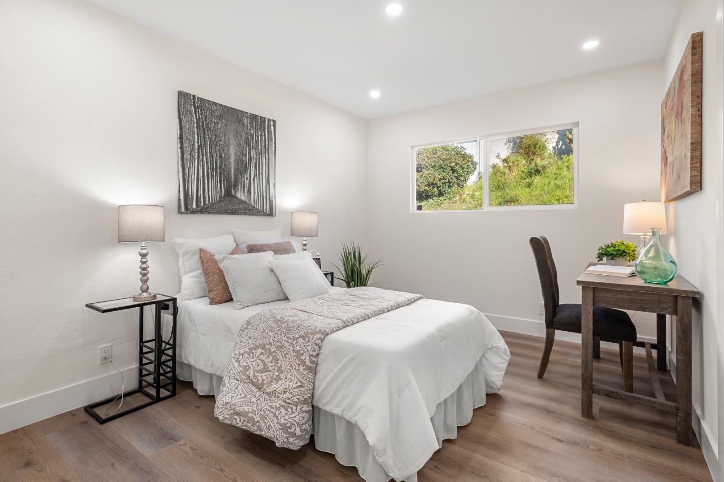 1014 Viewpointe Boulevard Rodeo, CA 94572 - Photo 11 of 20 a bedroom with a bed and a table in it