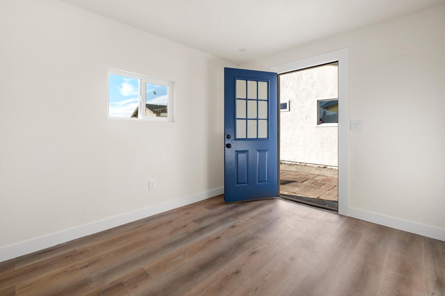 1014 Viewpointe Boulevard Rodeo, CA 94572 - Photo 16 of 20 an empty room with wooden floor and windows