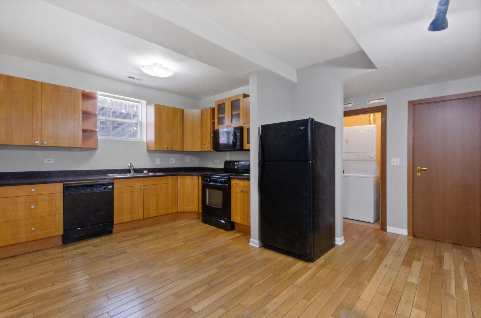 3908 West Ainslie Street, Unit G Chicago, IL 60625 - Photo 4 of 16 a kitchen with a refrigerator and a sink