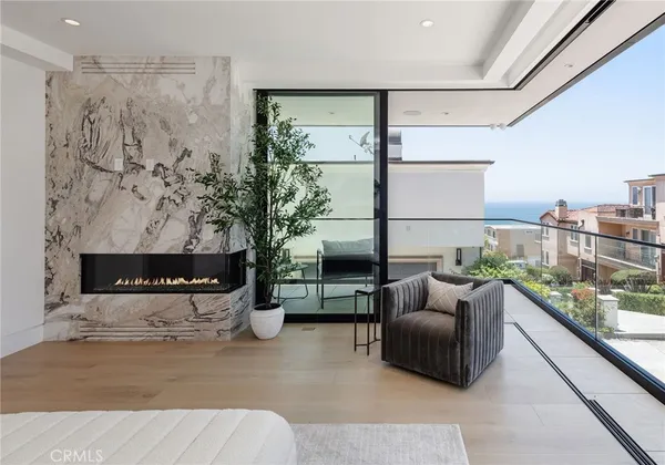 a bedroom with a large bed and a potted plant