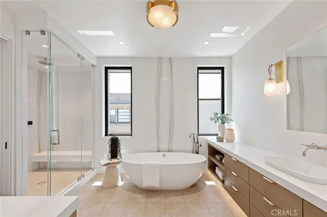 a bathroom with a double vanity sink toilet and shower