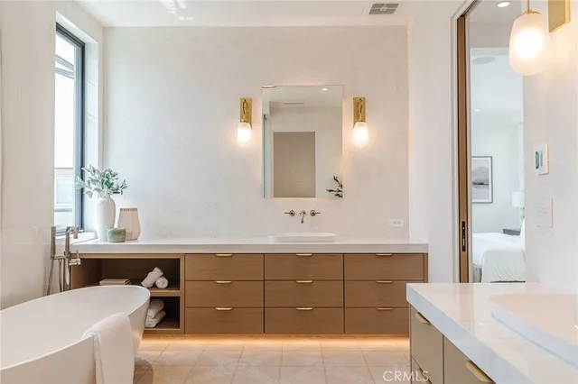 a bathroom with a sink a toilet and mirror