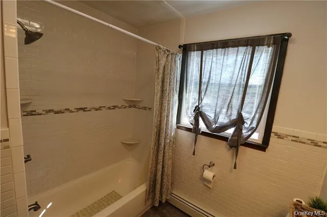 a bathroom with a shower and a tub