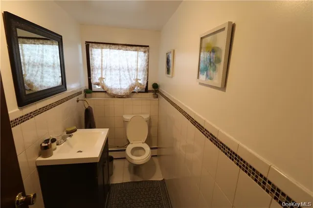 a bathroom with a sink mirror and toilet