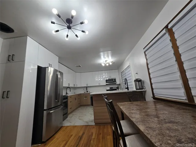 a kitchen with sink cabinets and stainless steel appliances
