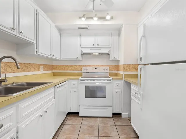 a kitchen with a sink cabinets and stainless steel appliances