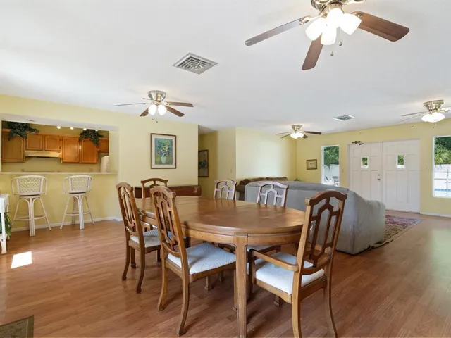 a living room with furniture ceiling fan and a window