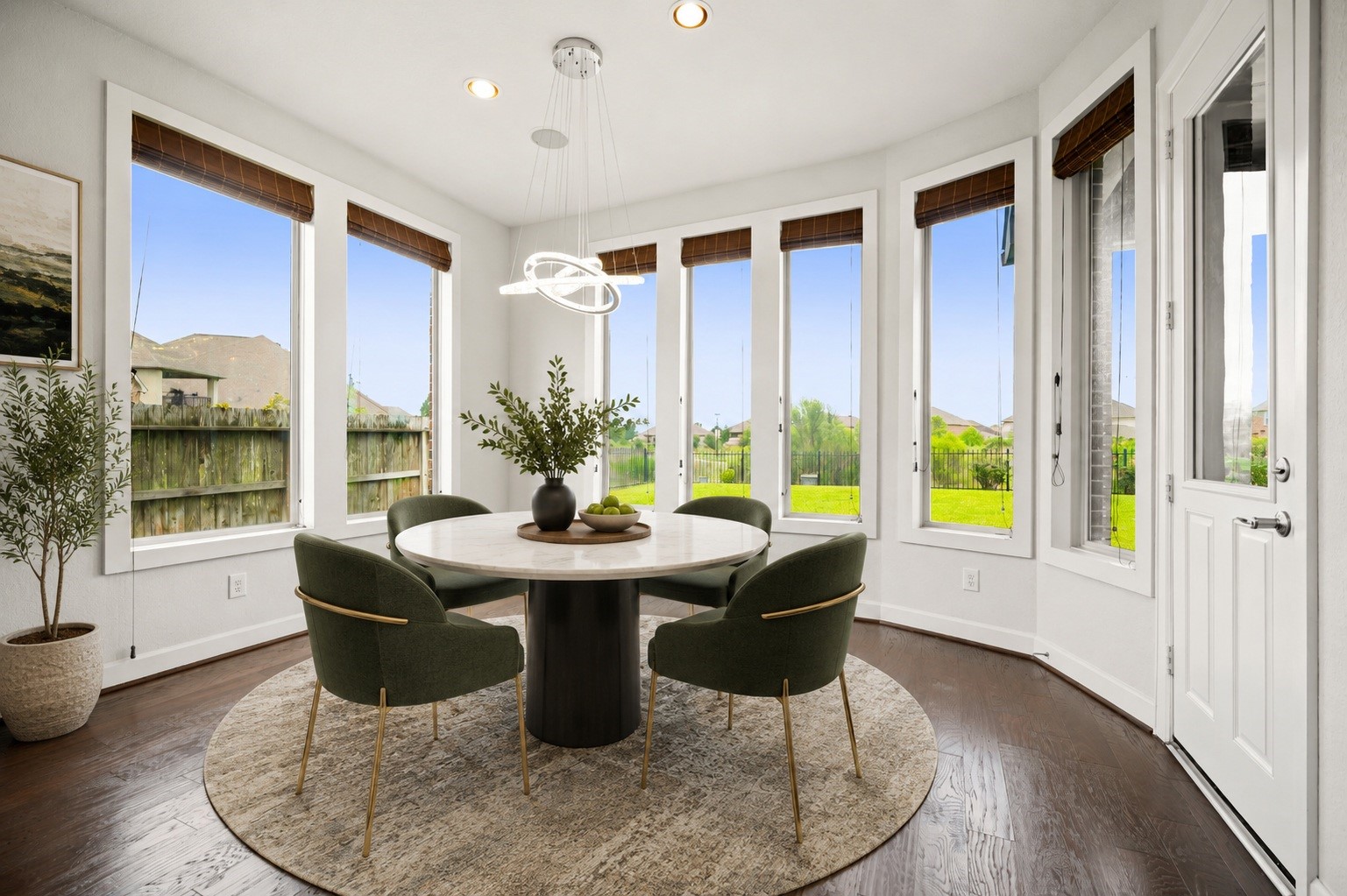 3622 Sage Hollow Drive Spring, TX 77386 - Photo 15 of 46 The bright breakfast area serves as a sunny spot for daily dining, featuring a modern light fixture and an entire wall of floor-to-ceiling fixed glass windows looking out to the property's serene grounds. Virtually staged.