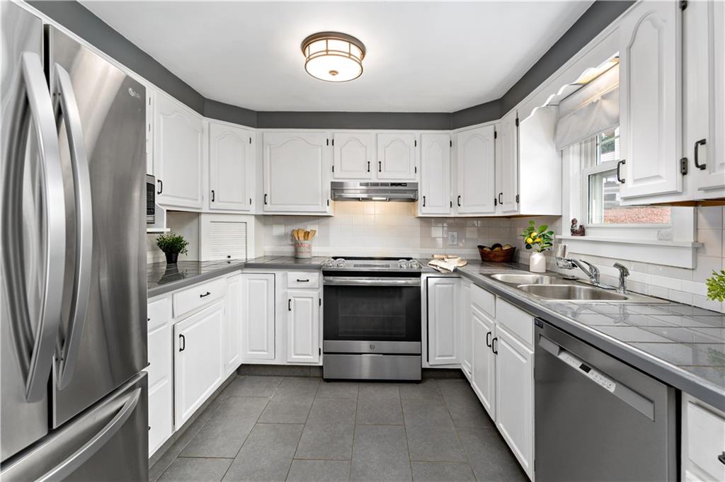 3181 Mellott Road Pittsburgh, PA 15227 - Photo 11 of 34 a kitchen with stainless steel appliances granite countertop a refrigerator sink and cabinets