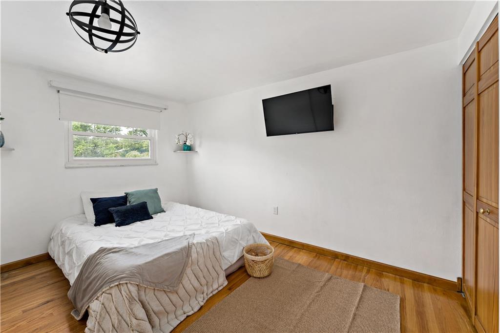 3181 Mellott Road Pittsburgh, PA 15227 - Photo 19 of 34 a bedroom with a bed and a flat tv screen on dresser