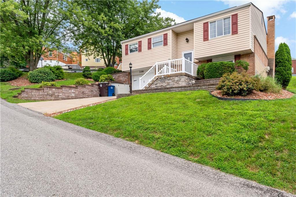 3181 Mellott Road Pittsburgh, PA 15227 - Photo 2 of 34 a front view of a house with a garden and plants