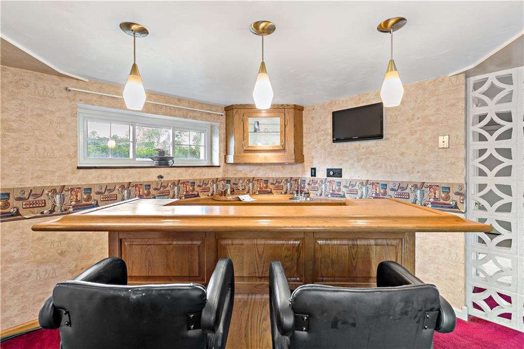 3181 Mellott Road Pittsburgh, PA 15227 - Photo 25 of 34 a dining table sitting next to a bathroom with a sink and mirror