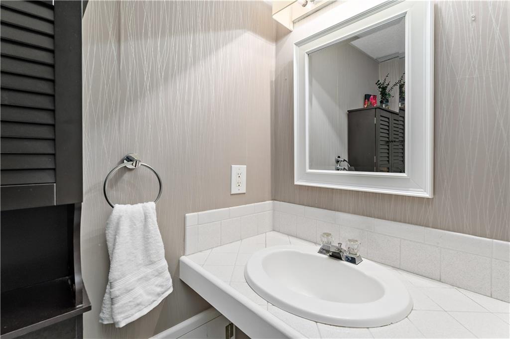 3181 Mellott Road Pittsburgh, PA 15227 - Photo 27 of 34 a bathroom with a sink and a mirror