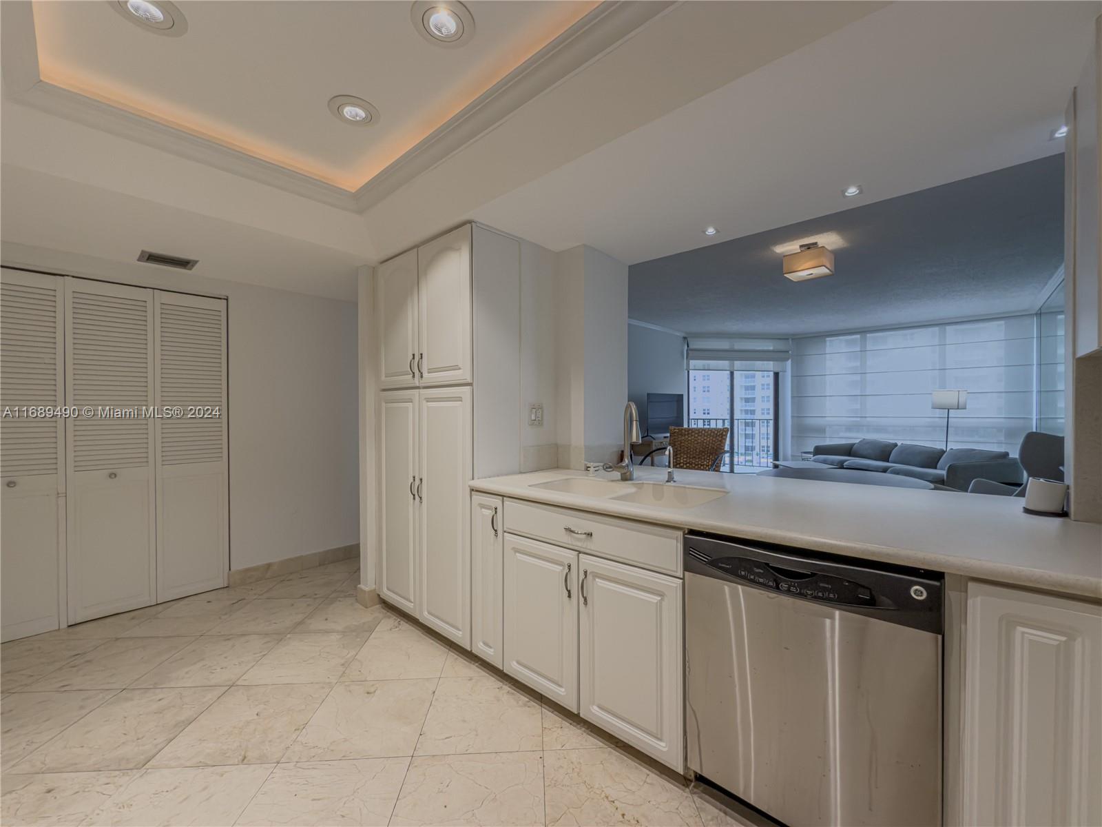 520 Brickell Key Drive, Unit A705 Miami, FL 33131 - Photo 12 of 66 a kitchen with a sink and cabinets