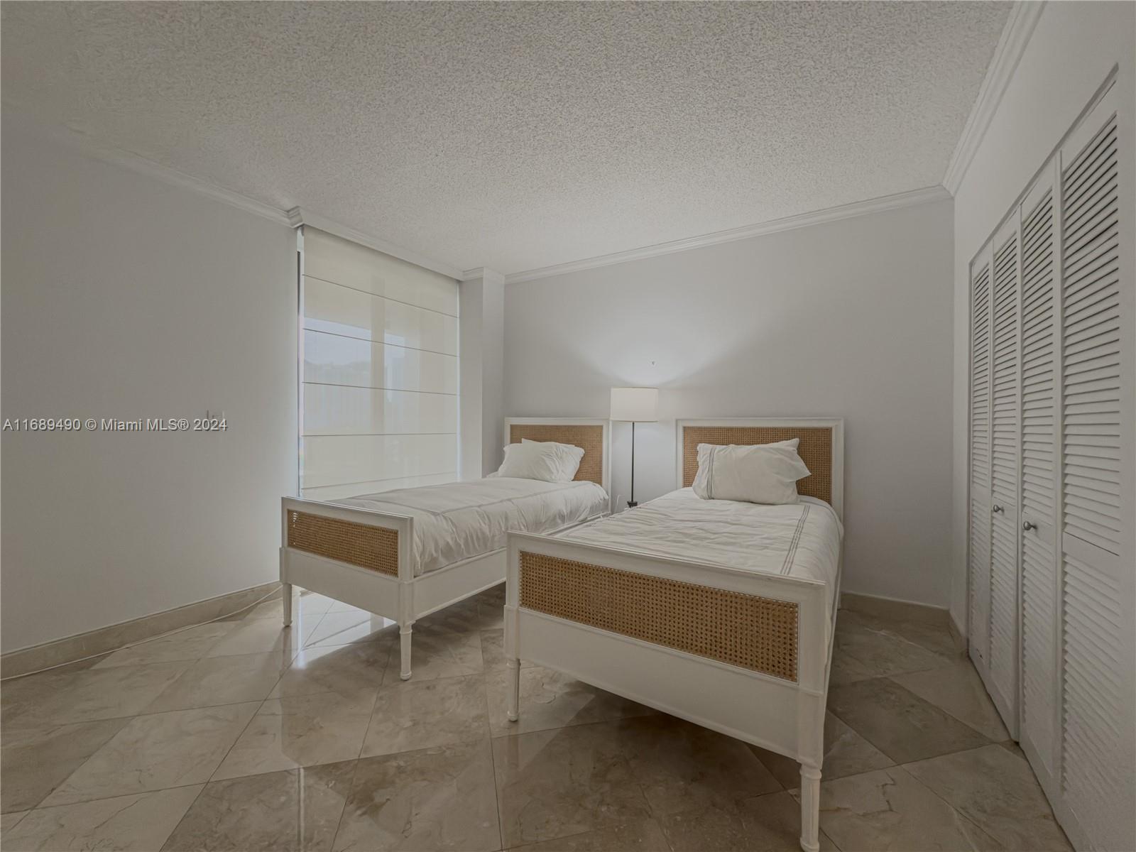 520 Brickell Key Drive, Unit A705 Miami, FL 33131 - Photo 17 of 66 a bedroom with two beds and a table