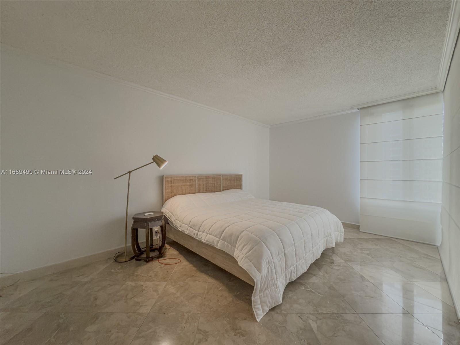 520 Brickell Key Drive, Unit A705 Miami, FL 33131 - Photo 23 of 66 a bed room with a bed and a table