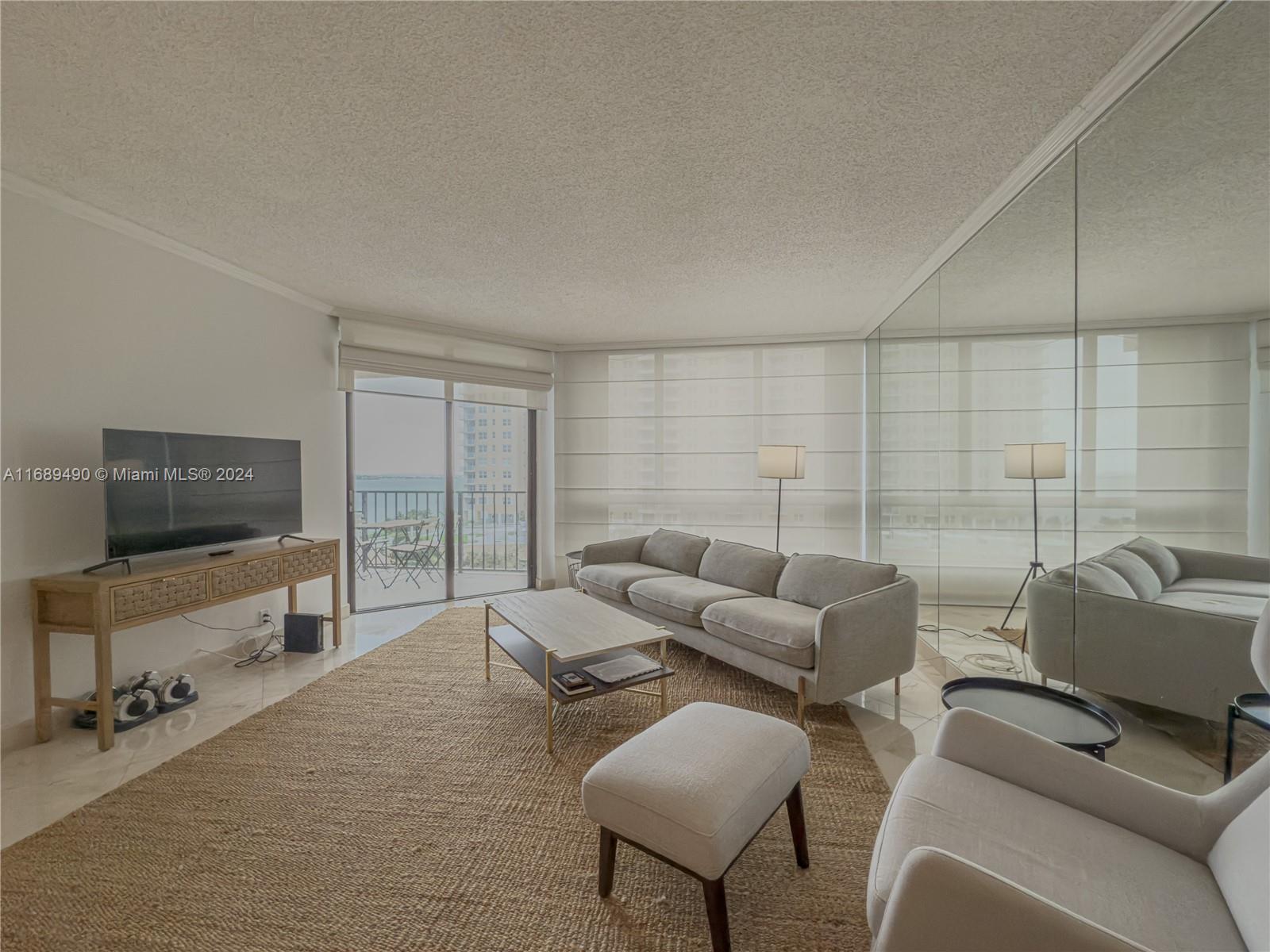 520 Brickell Key Drive, Unit A705 Miami, FL 33131 - Photo 3 of 66 a living room with furniture and a flat screen tv