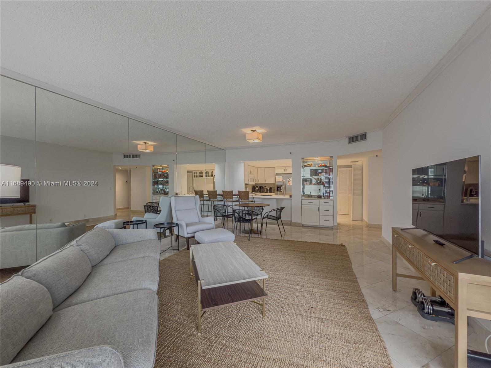 520 Brickell Key Drive, Unit A705 Miami, FL 33131 - Photo 4 of 66 a living room with furniture and a flat screen tv