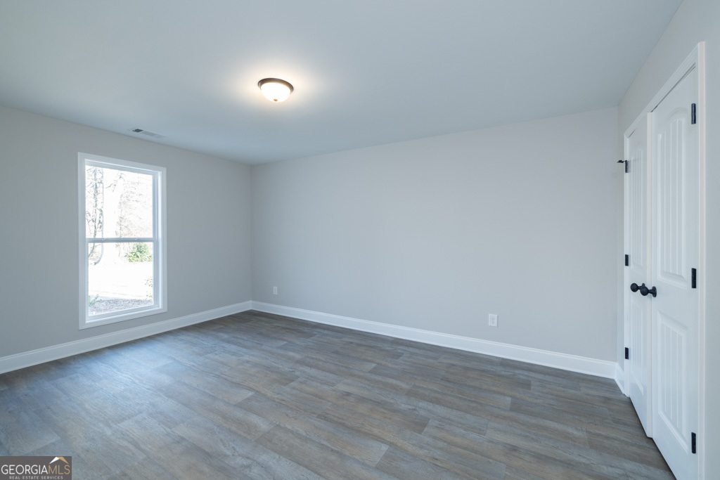 300 Grady Brock Road, Unit 20 Martin, GA 30557 - Photo 17 of 26 a view of an empty room with wooden floor and a window