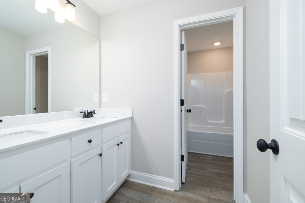300 Grady Brock Road, Unit 20 Martin, GA 30557 - Photo 18 of 26 a bathroom with a double vanity sink a mirror and shower