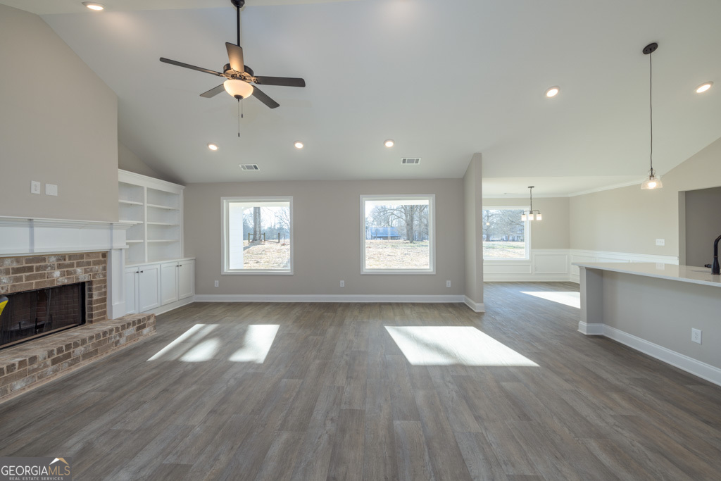 300 Grady Brock Road, Unit 20 Martin, GA 30557 - Photo 4 of 26 an empty room with wooden floor fireplace and windows