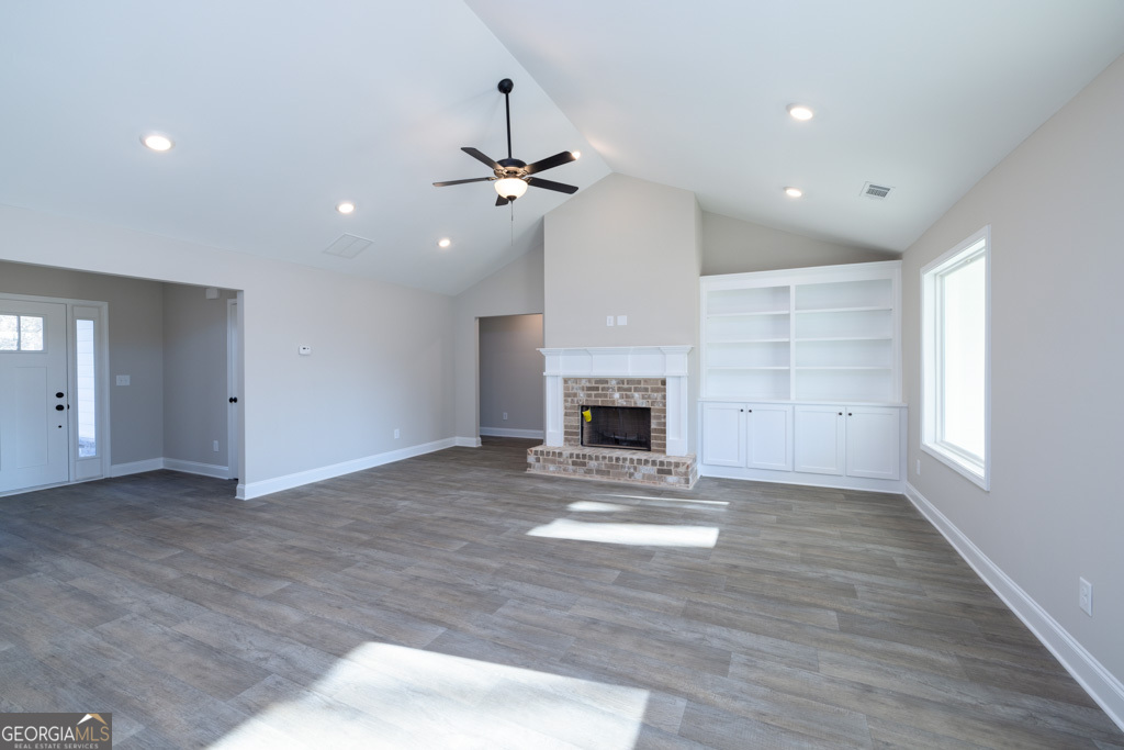 300 Grady Brock Road, Unit 20 Martin, GA 30557 - Photo 6 of 26 a view of an empty room with a fireplace and a window