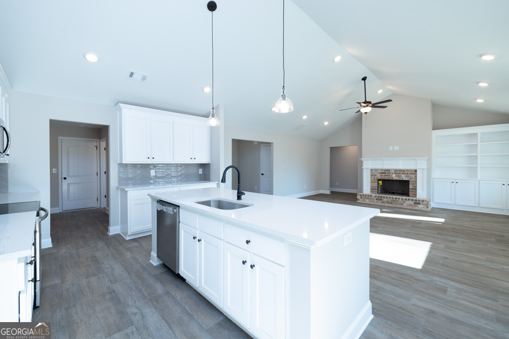 300 Grady Brock Road, Unit 20 Martin, GA 30557 - Photo 10 of 26 a large kitchen with kitchen island a stove a sink a center island and wooden floor