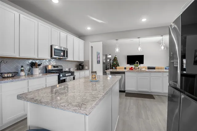 a view of kitchen with sink microwave and refrigerator