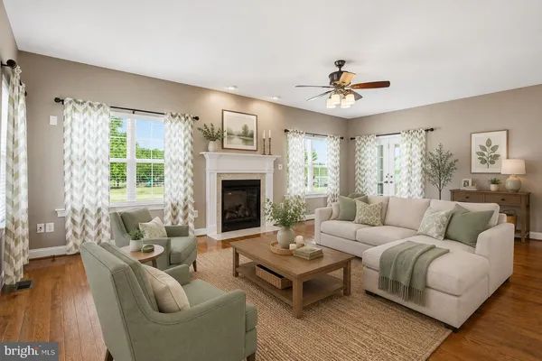 a living room with furniture a chandelier and a fireplace