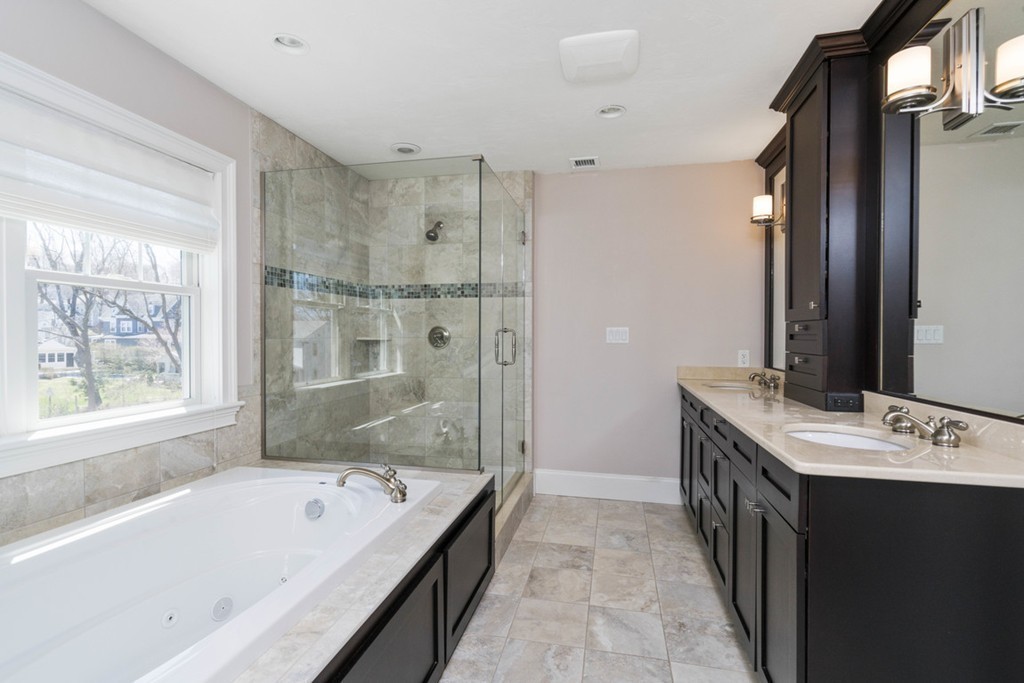 38 Smith Place Cohasset, MA 02025 - Photo 16 of 28 a bathroom with a tub sink and mirror