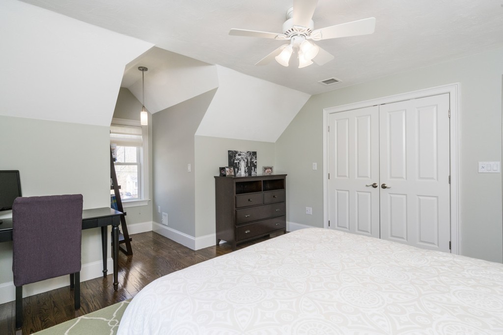 38 Smith Place Cohasset, MA 02025 - Photo 20 of 28 a bedroom with a bed and a chandelier