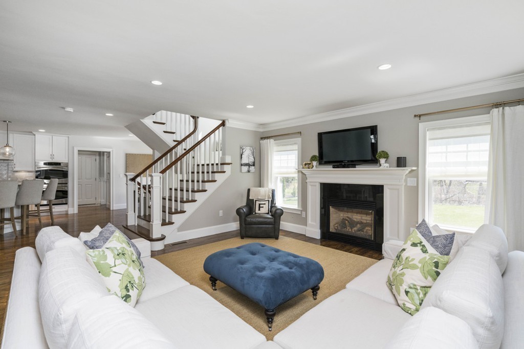 38 Smith Place Cohasset, MA 02025 - Photo 6 of 28 a living room with furniture a fireplace and a flat screen tv