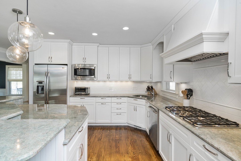 38 Smith Place Cohasset, MA 02025 - Photo 10 of 28 a kitchen with stainless steel appliances granite countertop a sink stove and refrigerator
