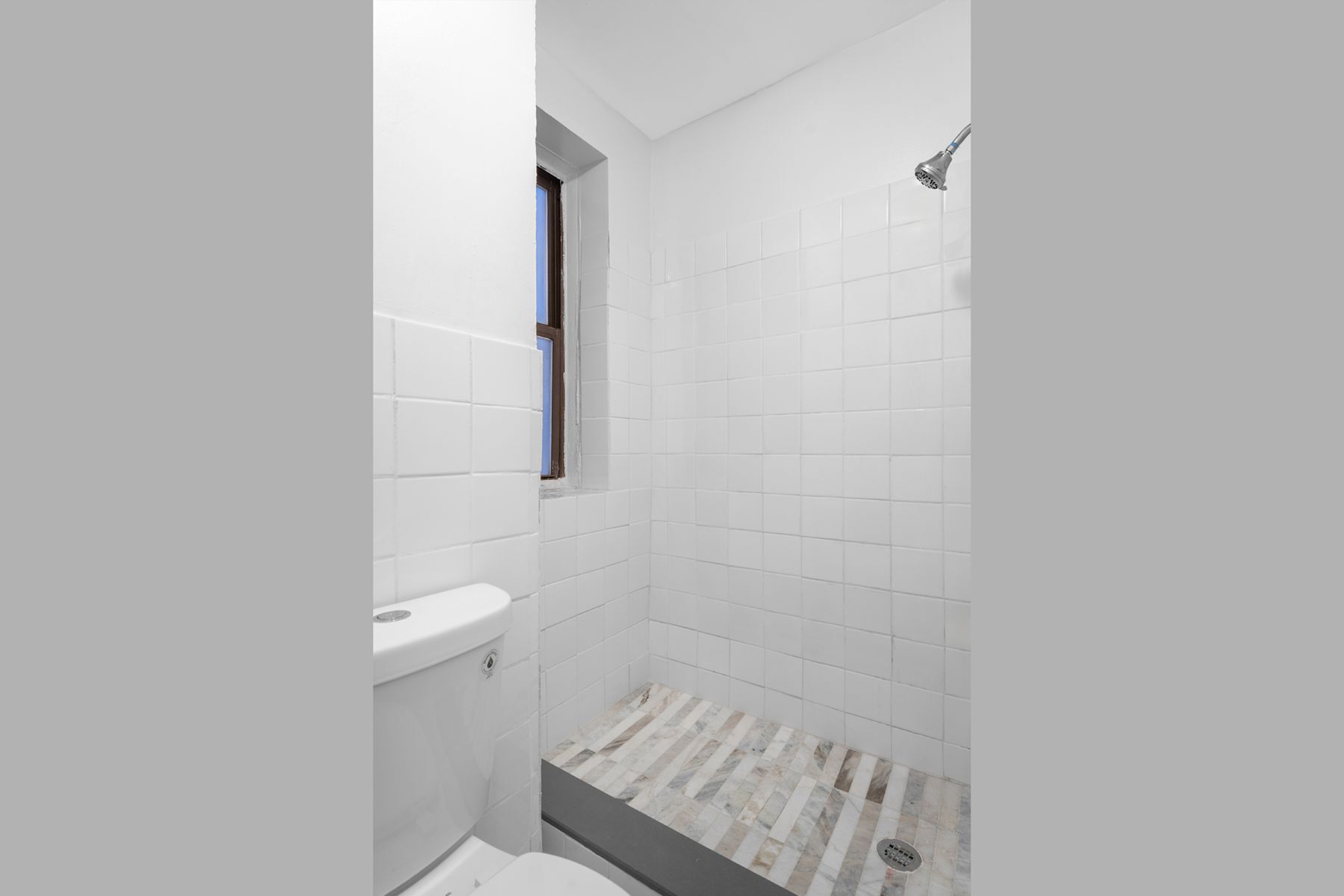 246 East 51st Street, Unit 7 Manhattan, NY 10022 - Photo 2 of 8 a bathroom with a shower