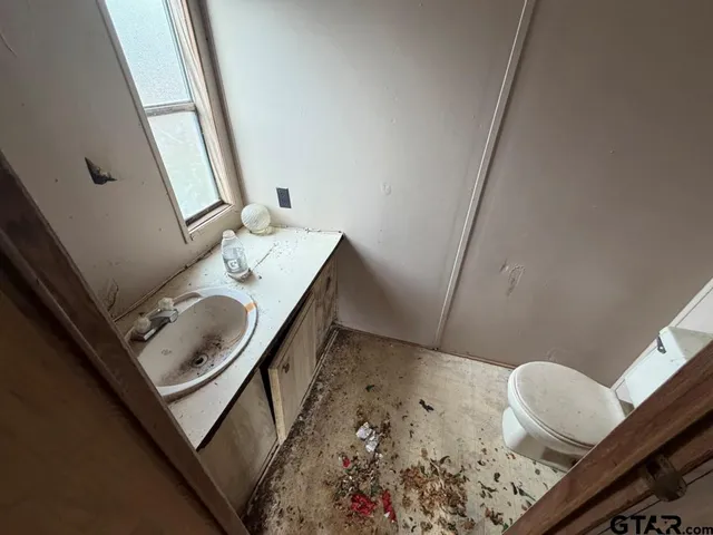 a bathroom with a sink and mirror