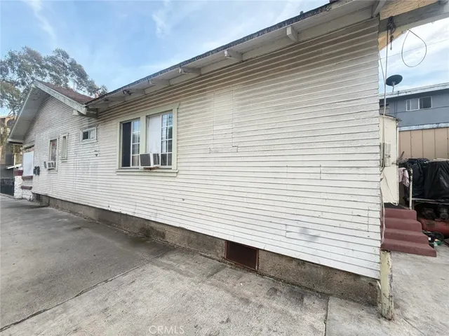 a view of a white house with a small space